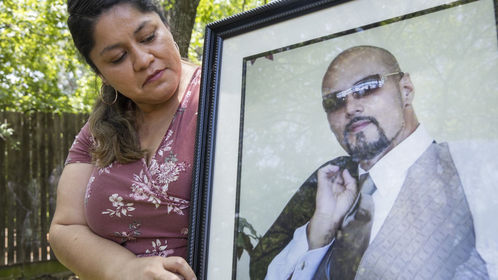 Parkland Health & Hospital System nurse Dolores Diaz poses for a photo with a photo of her late husband on July 9, 2020 at their home in Grand Prairie. Dolores' husband Juan died unexpectedly in late June. (Juan Figueroa / Staff Photographer)