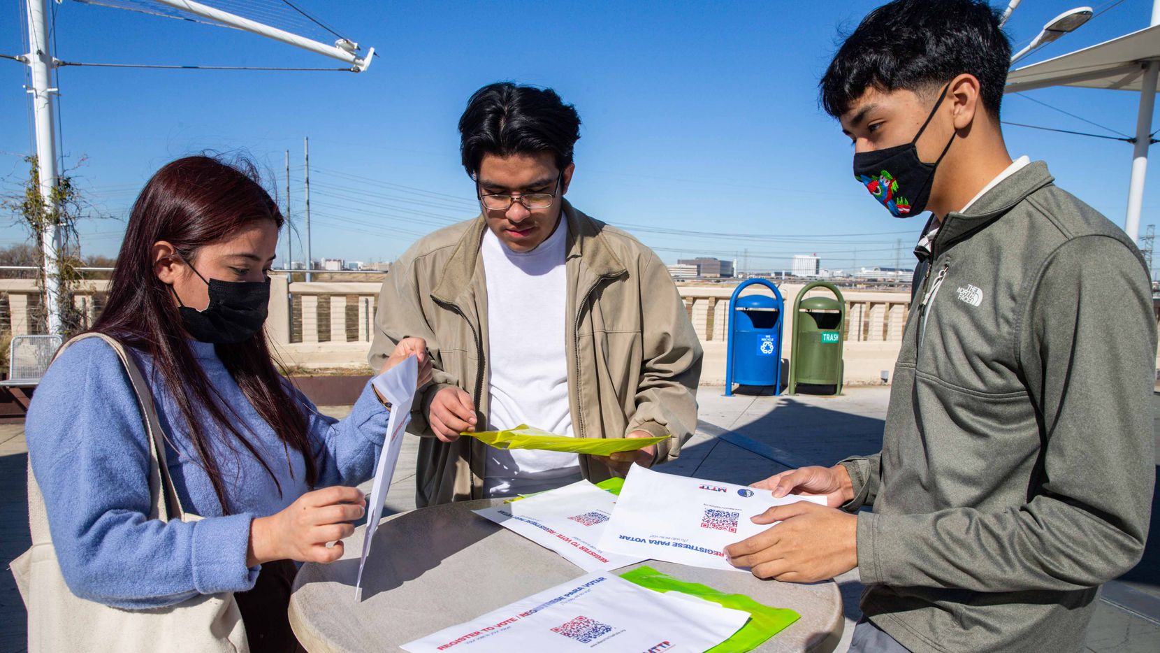From left, high schoolers Daniela De La Cruz, Adrian Sanchez, and Angel Garcia Donjuan, show the pamphlets with information about the past presidential elections that they used to inform students through their student-run organization, SVEC. Going into 2021, they are keeping their peers excited about voting for local elections by keeping them informed and engaged in Dallas on Monday, December 21, 2020. (Lola Gomez/Staff Photographer)