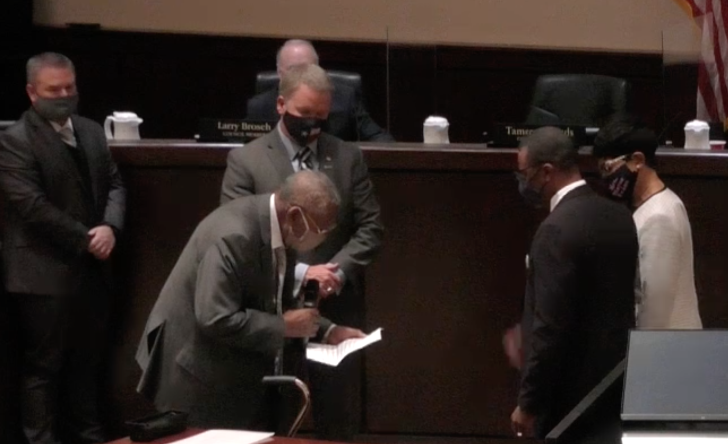 Mayor Evans stands with his wife Monday while being sworn in by Judge Clifford Davis
