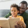 African American father and son reading