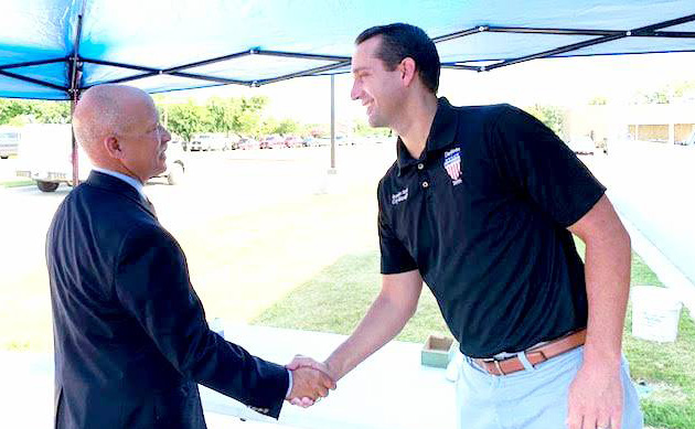 District Attorney John Creuzot greets DeSoto City Manager Brandon Wright