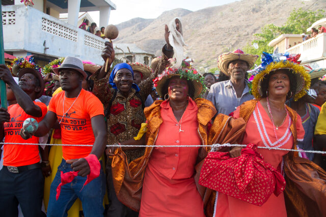 Celebrants hold maracas