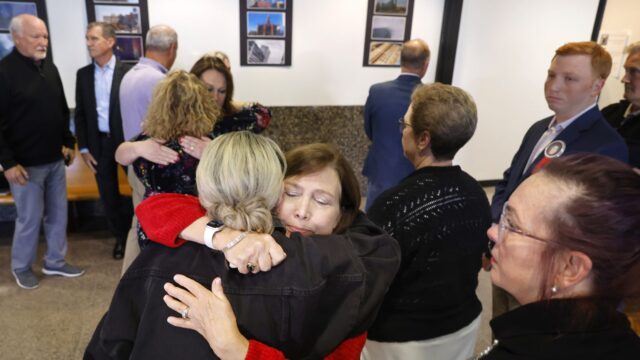 Loren Adair Smith (facing) receives a hug from Cheryl Pangburn