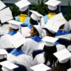Graduates look for their parents in the audience during the Wilmer-Hutchins High School graduation in June.(Nathan Hunsinger / Staff Photographer)