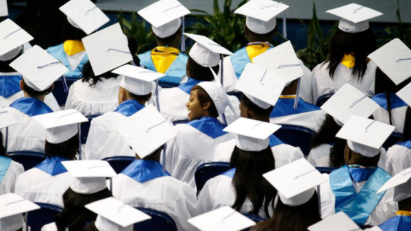 Graduates look for their parents in the audience during the Wilmer-Hutchins High School graduation in June.(Nathan Hunsinger / Staff Photographer)