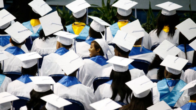 Graduates look for their parents in the audience during the Wilmer-Hutchins High School graduation in June.(Nathan Hunsinger / Staff Photographer)