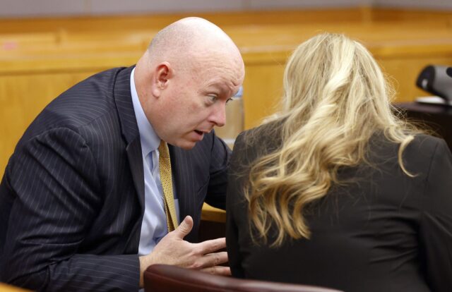 Prosecutor Glen Fitzmartin (left) confers with Assistant 