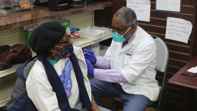 Pharmacist Serge Dorime delivers a coronavirus vaccine