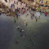 Immigrants, many from Haiti, are seen wading between the U.S. and Mexico on the Rio Grande on Sept. 21, 2021