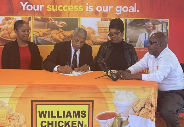 Alythina Wynn, Shauna Brown and TIm Williams look on as Hiawatha Williams