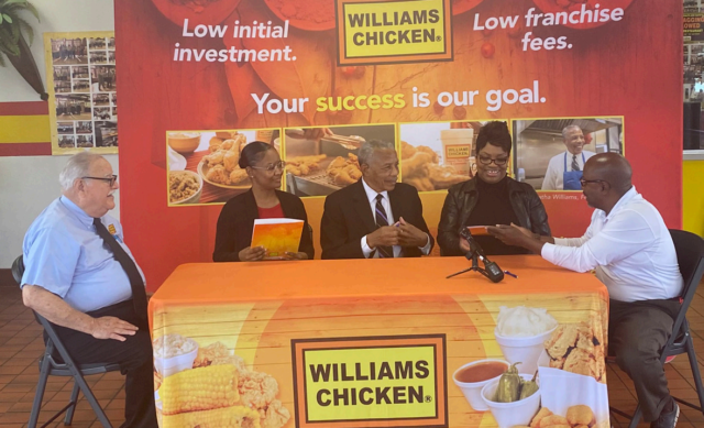 Alythina Wynn and Shauna Brown hold on to contracts as they are congratulated by William Chicken executive