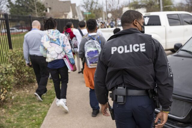 DISD police officer walked behind students heading home