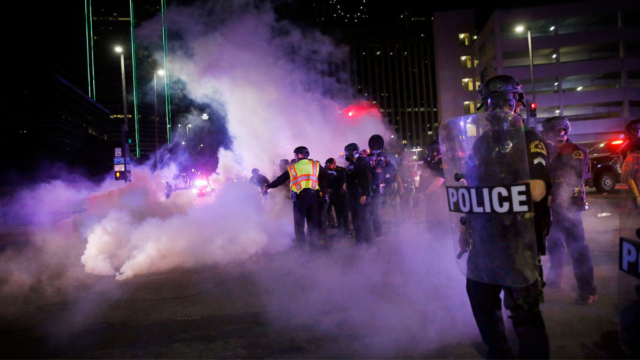 Dallas Police tactical officers fire rounds of tear gas at protestors