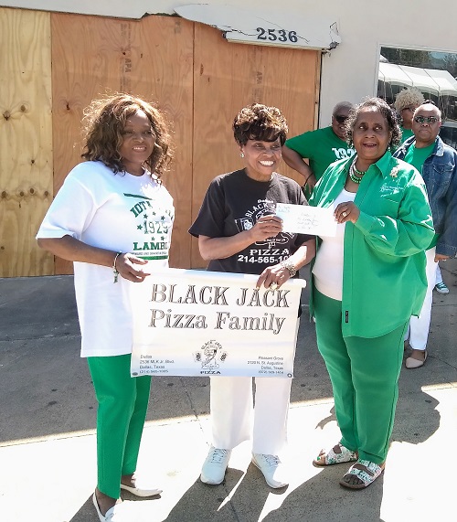 Iota Phi Lambda presents a check to help Ms. Dorothy Jones and the Black Jack Pizza Family Rebuild