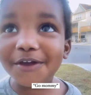 TODDLER CHEERING HIS MOTHER ON