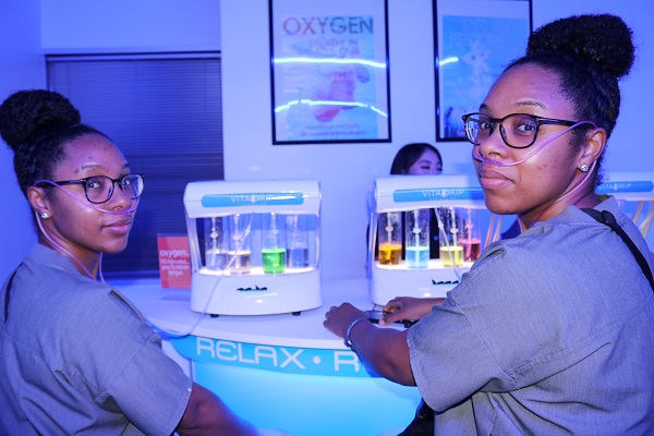 Twin sisters sitting at Oxygen Bar at VitaDrip & Wellness Spa