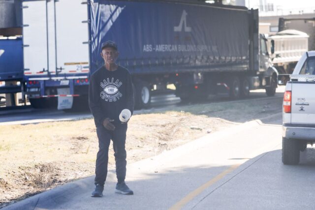 man stands in a traffic lane