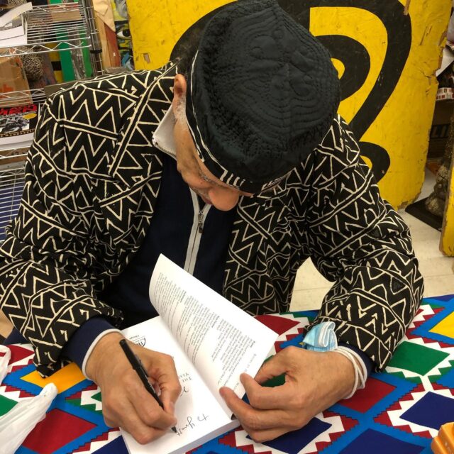 Haki Madhubuti signing his book Village Black