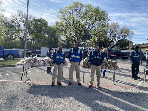 Police officers volunteering at the Table Spring Break mobile pantry food drive 