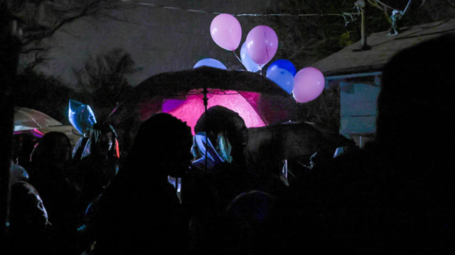 Community members gathered for a prayer service and balloon