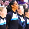 An all-women officiating crew stands
