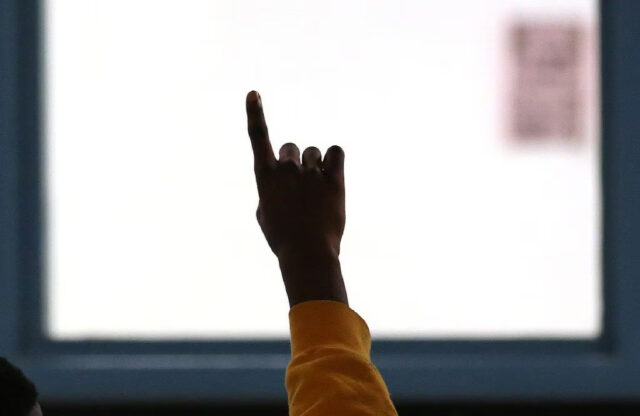 A juvenile offender raises his hand