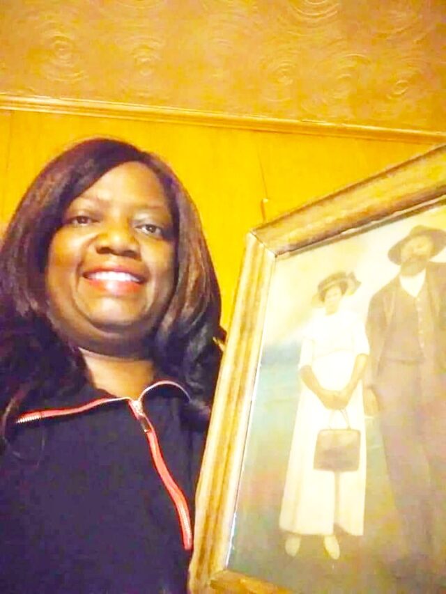 Candace Wicks with a photo of her maternal ancestors Jeff and Hanna Hill