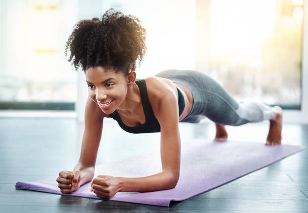 Shot of a beautiful young woman exercising indoors