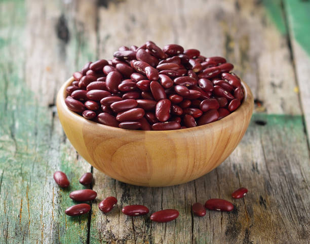 Red beans in the wooden bowl on old wooden