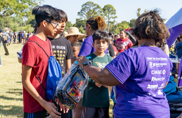 Volunteers hand out over 1,000 backpacks