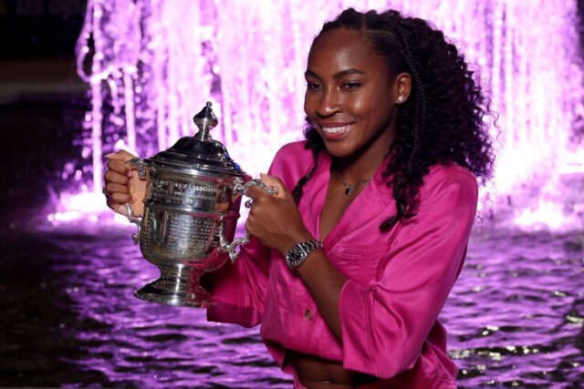 A girl holding trophy