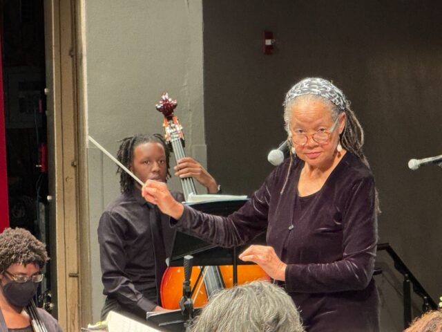 Dr. Anne Lundy directs orchestra