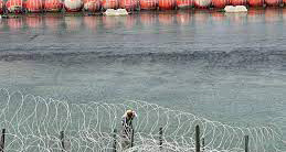 Barbed razor wire and buoy barriers at southern border