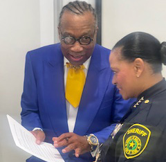 Commissioner John Wiley Price and Sheriff Marian Brown review the findings.