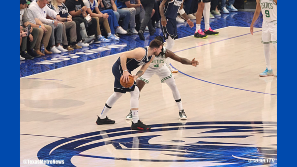 Luka Doncic keeps hte ball away from Celtics Jrue Holiday