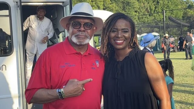 City of Lancaster Mayor Clyde C. Hairston and City of DeSoto Mayor Rachel L. Proctor at their cities joint Fourth of July Celebration as Soul, Funk, and R&B legends the Bar-Kays arrive in the background.