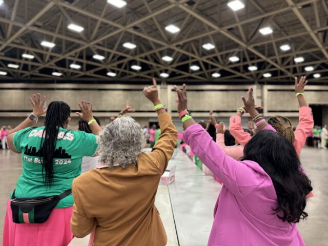 Sorority sisters hold pinkies