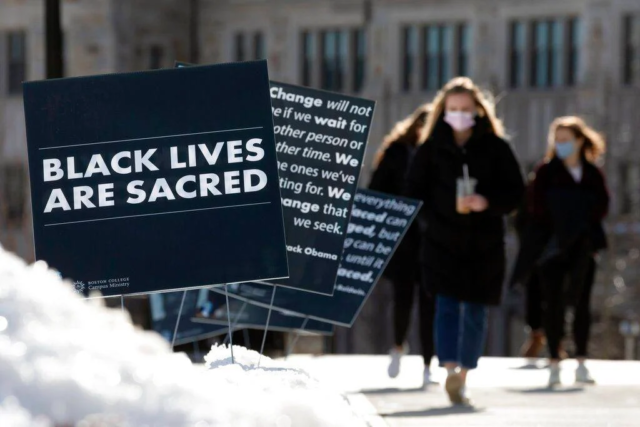 Students walk past Black History Month posters