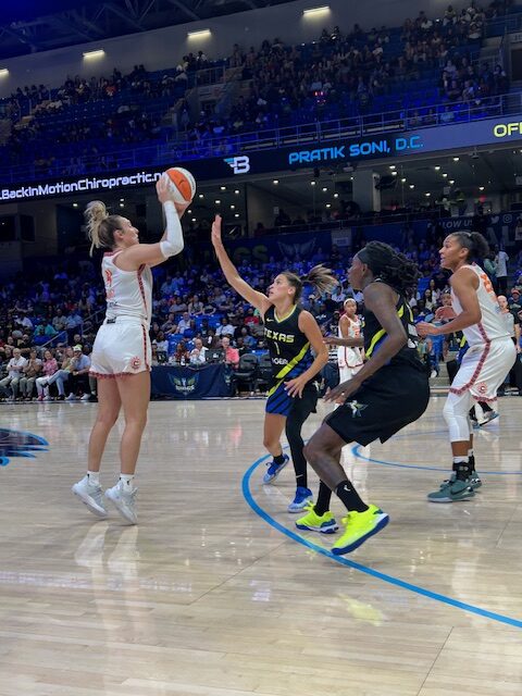 Connecticut Sun's Marina Mabrey shoots over Dallas Wings players