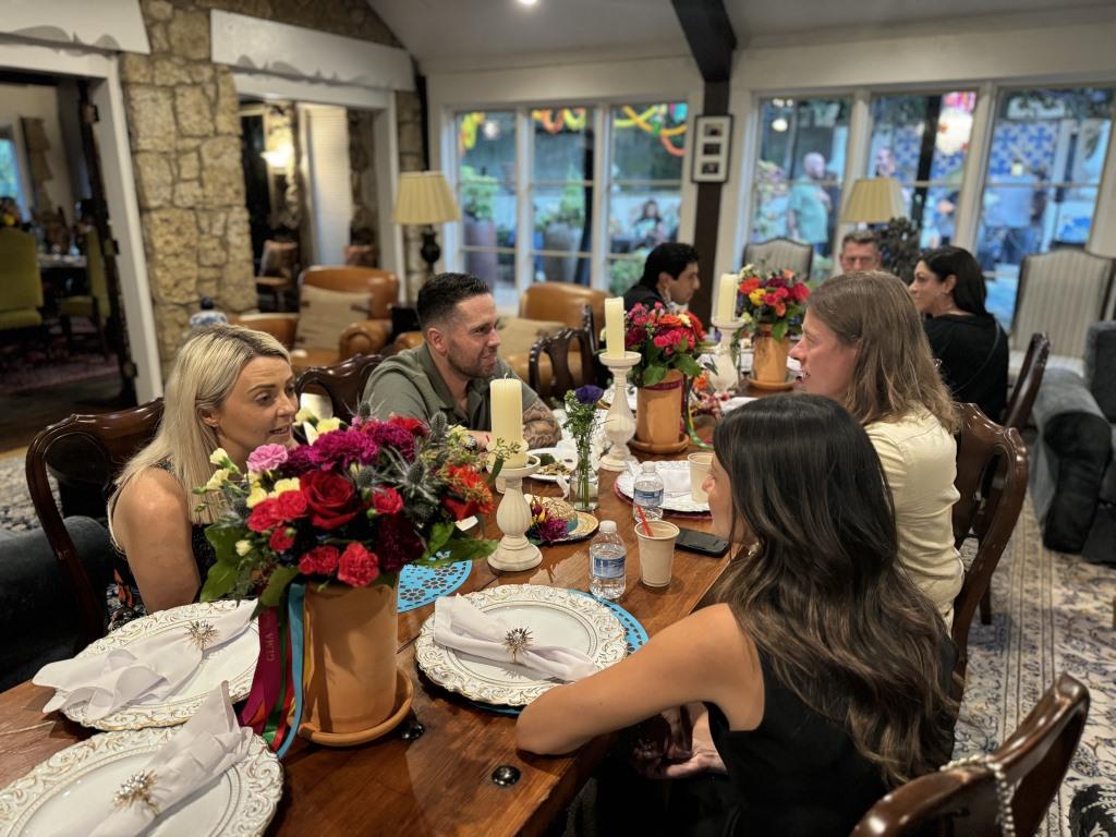 Attendees socializing during HCDFW Rosie Casals Lifetime Achievement Celebration at residence in Dallas
