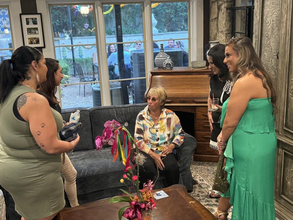 Attendees surround Rosie Casals during HCDFW Rosie Casals Lifetime Achievement Celebration at residence in Dallas