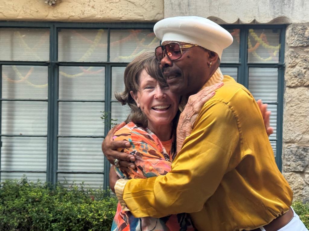 Larry York hugs his high school tennis instructor Joycelynn Grigson during HCDFW Rosie Casals Lifetime Achievement Celebration at residence in Dallas