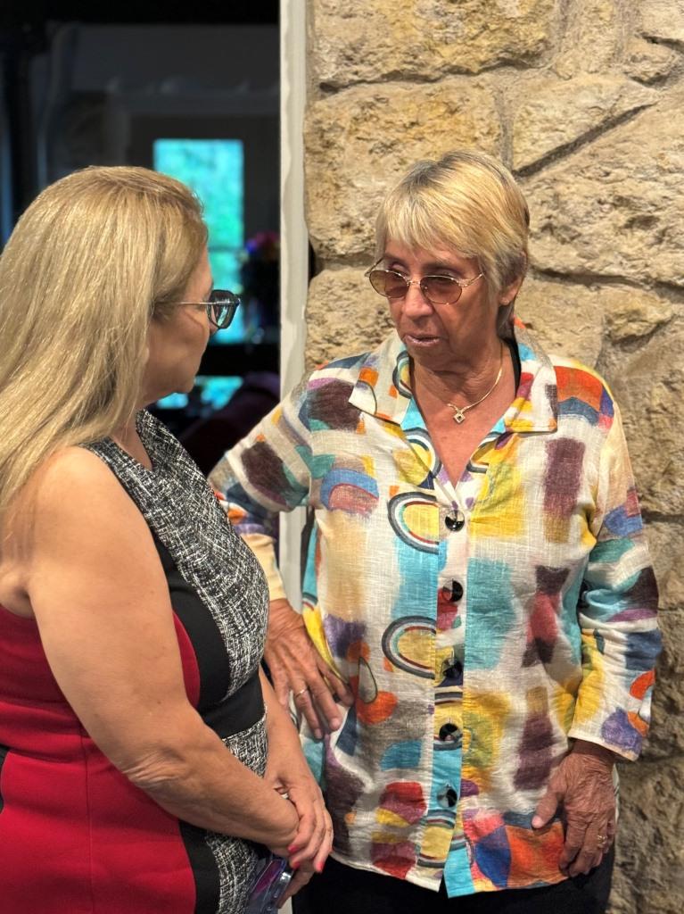 Rosie Casals speaking with attendee during HCDFW Rosie Casals Lifetime Achievement Celebration at residence in Dallas